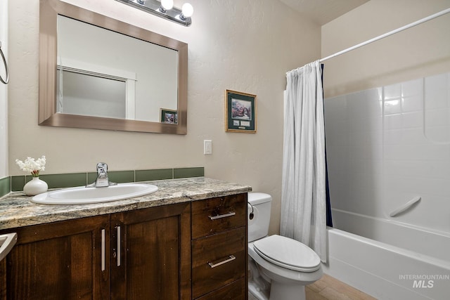 bathroom with shower / bathtub combination with curtain, vanity, and toilet