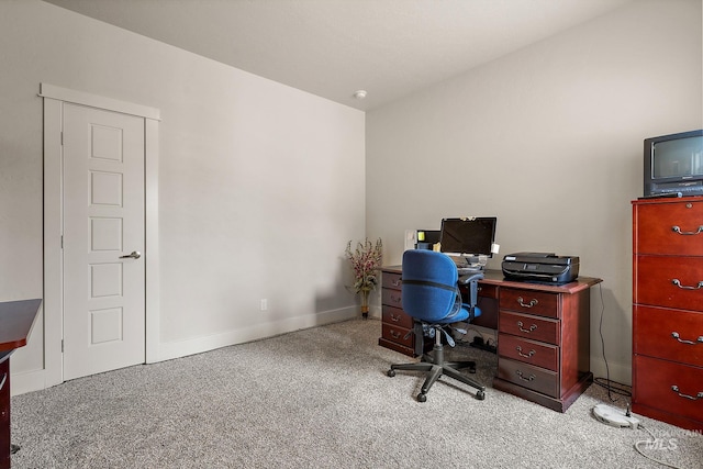 carpeted office space featuring baseboards