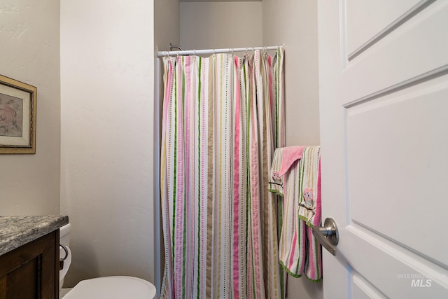 full bath featuring curtained shower, vanity, and toilet