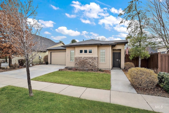 view of front of home featuring driveway, stone siding, an attached garage, fence, and stucco siding