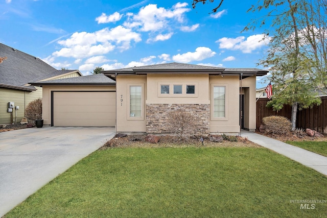 prairie-style home with driveway, stucco siding, an attached garage, fence, and a front yard