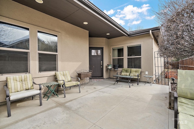 view of patio featuring fence and an outdoor living space