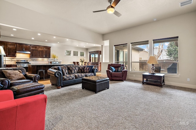 living room with recessed lighting, light colored carpet, visible vents, ceiling fan, and baseboards