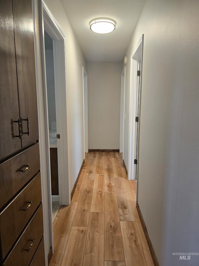 hall with light wood-type flooring