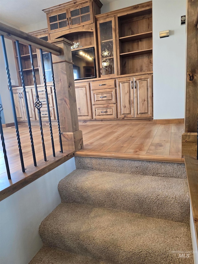 stairs with hardwood / wood-style floors