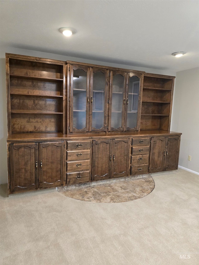 unfurnished living room featuring light colored carpet