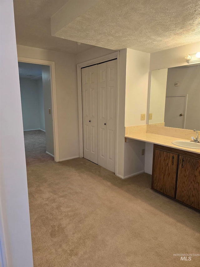 bathroom with vanity and a textured ceiling