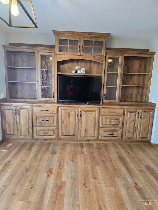 unfurnished living room featuring light wood-type flooring