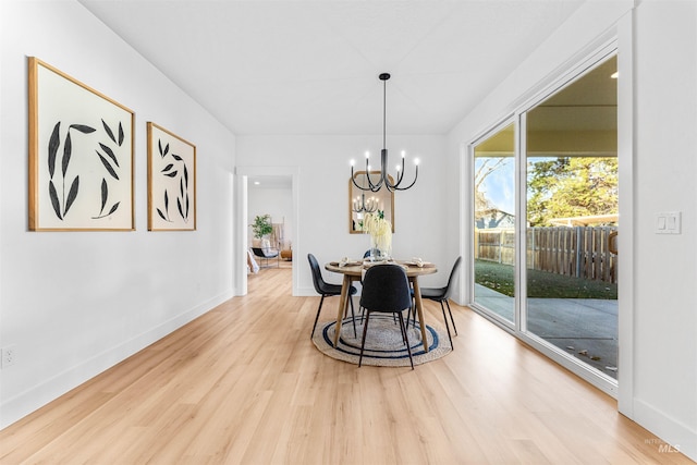 dining area featuring light hardwood / wood-style floors and a chandelier