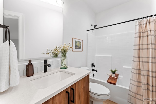 full bathroom featuring shower / bath combination with curtain, vanity, and toilet