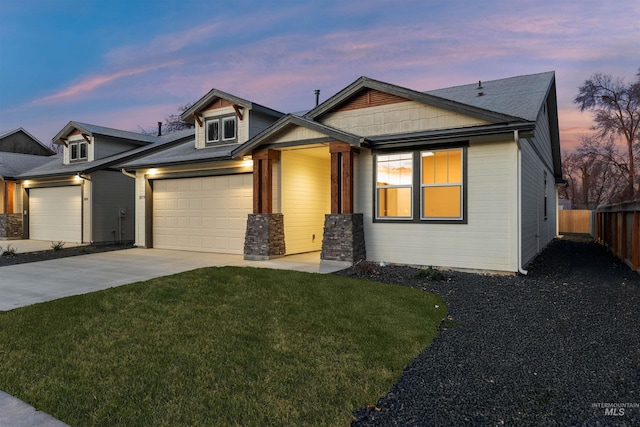 craftsman inspired home featuring a yard and a garage