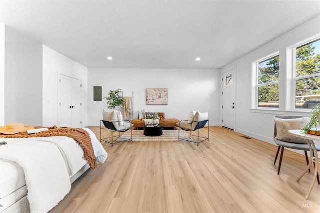 bedroom with light wood-type flooring and electric panel