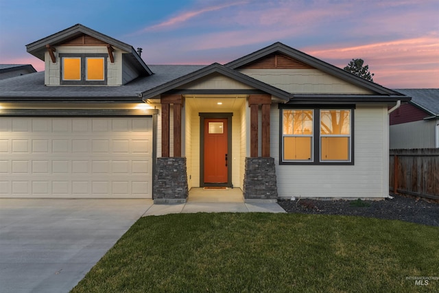 craftsman-style house with a yard and a garage