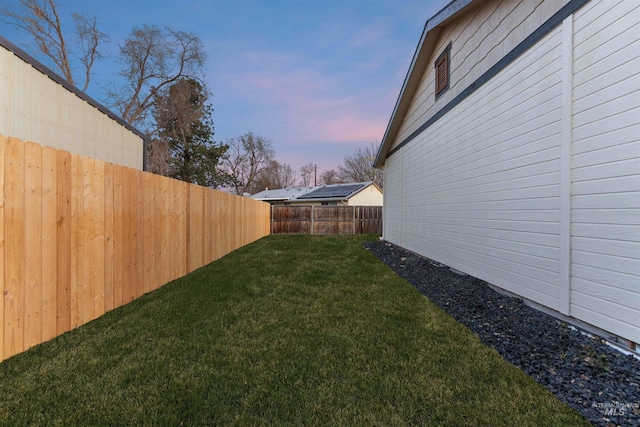 view of yard at dusk