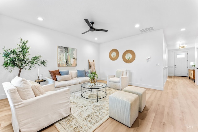 living room with ceiling fan and light wood-type flooring