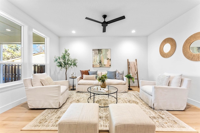 living room featuring ceiling fan and light hardwood / wood-style flooring