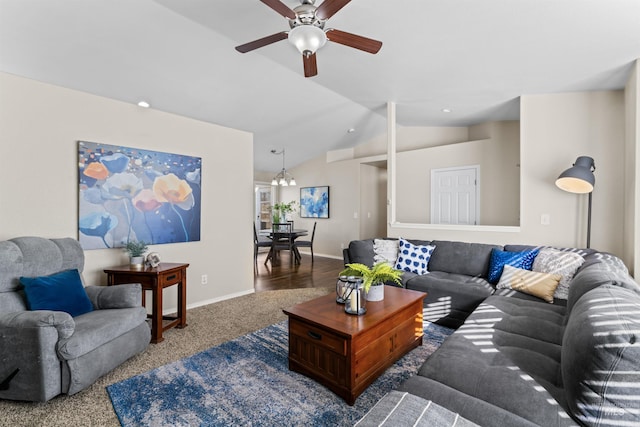 carpeted living area featuring vaulted ceiling, baseboards, and ceiling fan