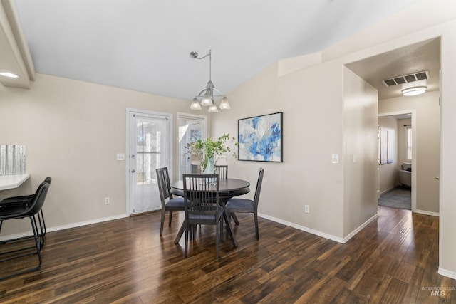 dining space with lofted ceiling, baseboards, visible vents, and dark wood finished floors