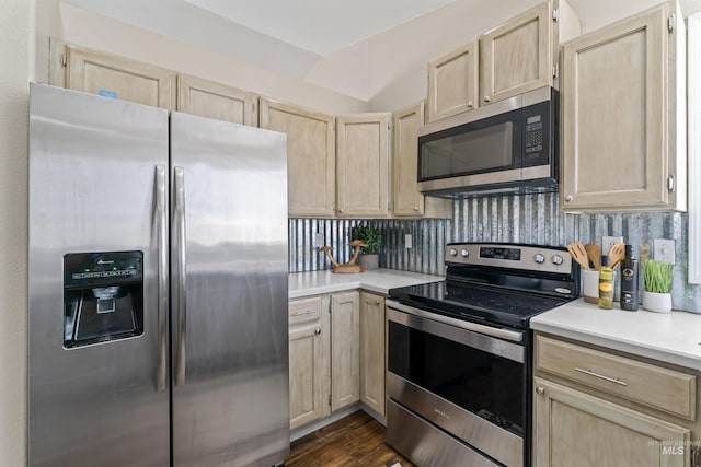 kitchen with stainless steel appliances, backsplash, and light brown cabinetry