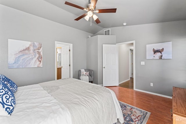 bedroom with lofted ceiling, wood finished floors, a ceiling fan, visible vents, and baseboards