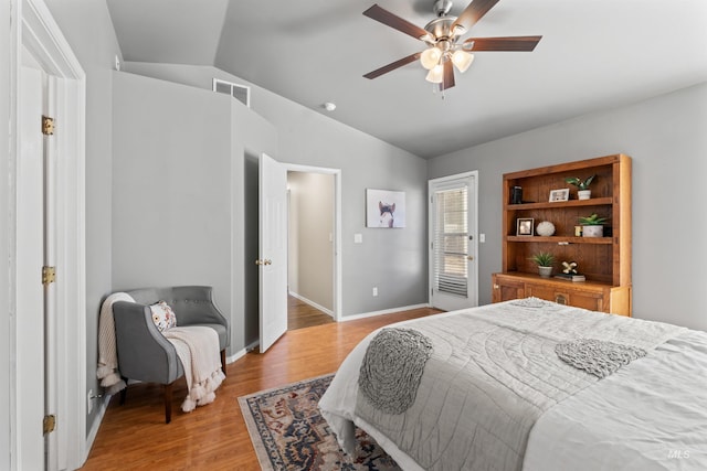 bedroom featuring visible vents, light wood-style flooring, a ceiling fan, vaulted ceiling, and baseboards