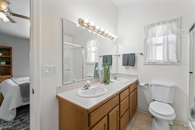 full bathroom with a sink, a shower with door, toilet, and connected bathroom