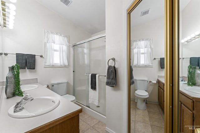 full bathroom featuring a wealth of natural light, visible vents, vanity, and toilet