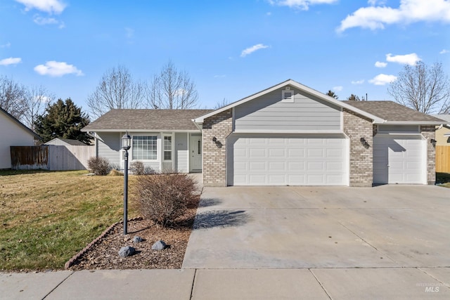 single story home with an attached garage, brick siding, fence, concrete driveway, and a front yard