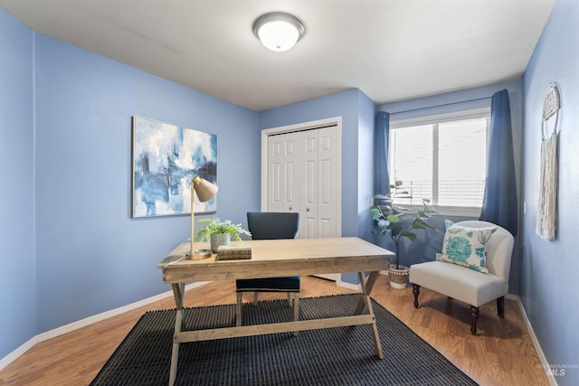 office featuring baseboards and wood finished floors