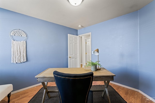 home office with light wood-type flooring and baseboards