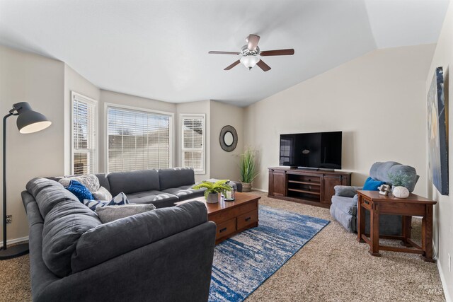 living area with lofted ceiling, carpet flooring, a ceiling fan, and baseboards