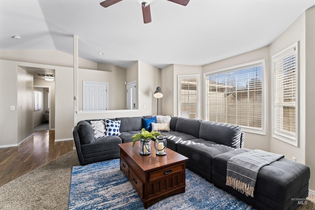 living room featuring vaulted ceiling, ceiling fan, dark wood-style floors, and baseboards