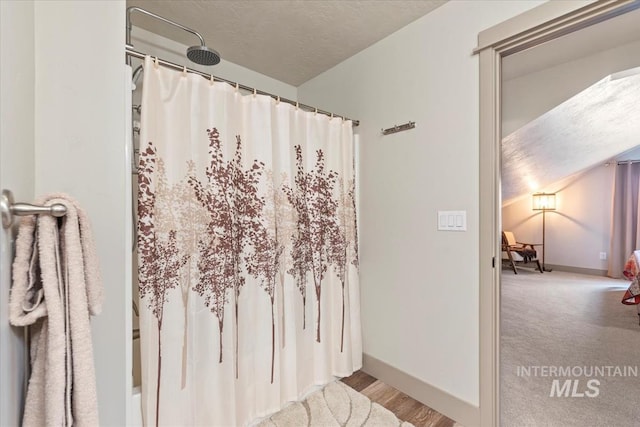 302 Broken Crk, Mccall, ID 83638 - bathroom featuring a shower with shower curtain, baseboards, and a textured ceiling