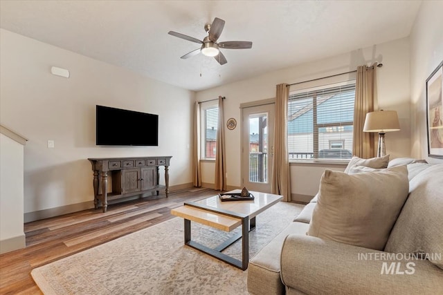 302 Broken Crk, Mccall, ID 83638 - living area featuring wood finished floors, plenty of natural light, baseboards, and ceiling fan