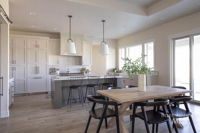 dining room with recessed lighting and wood finished floors