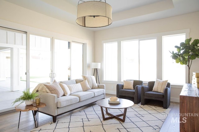 living room with light wood-type flooring and baseboards