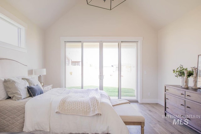 bedroom with light wood-style floors, baseboards, access to exterior, and multiple windows