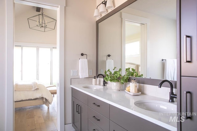 ensuite bathroom featuring plenty of natural light, double vanity, and a sink