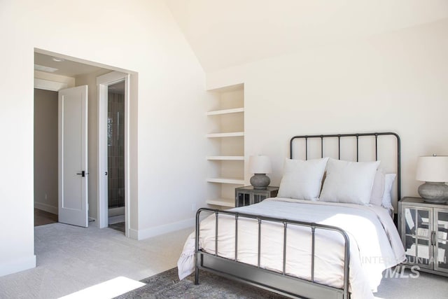 bedroom featuring lofted ceiling, carpet floors, and baseboards