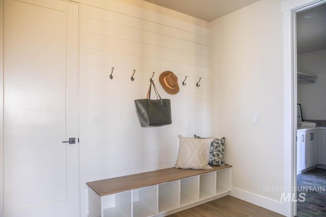 mudroom with wood finished floors and baseboards