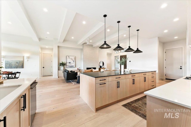 kitchen with light brown cabinets, hanging light fixtures, stainless steel dishwasher, dark stone countertops, and beamed ceiling