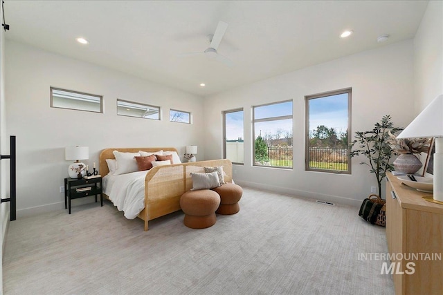 bedroom featuring ceiling fan and light carpet