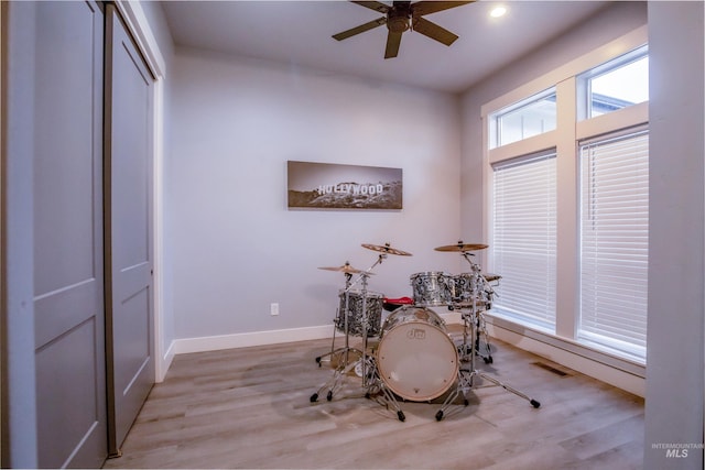 recreation room featuring ceiling fan and light hardwood / wood-style flooring