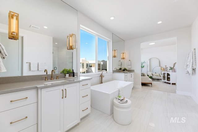 5935 E Marmount Ct, Boise, ID 83716 - full bathroom with vanity, a freestanding tub, recessed lighting, and a shower stall