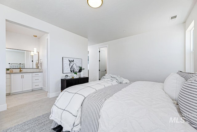 5935 E Marmount Ct, Boise, ID 83716 - bedroom with light colored carpet, ensuite bathroom, and light tile patterned flooring