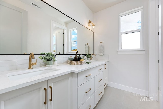 5935 E Marmount Ct, Boise, ID 83716 - full bathroom featuring double vanity, tile patterned flooring, and decorative backsplash