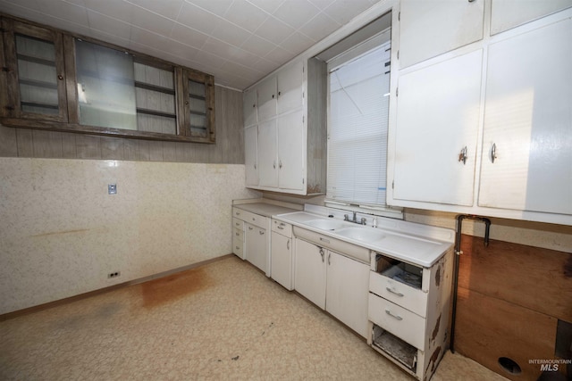 kitchen featuring white cabinetry and sink