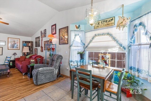 tiled dining area featuring vaulted ceiling and a wealth of natural light