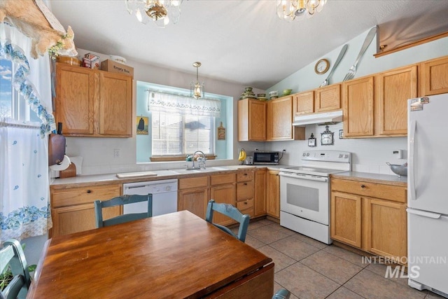 kitchen with white appliances, sink, decorative light fixtures, light tile patterned floors, and a notable chandelier