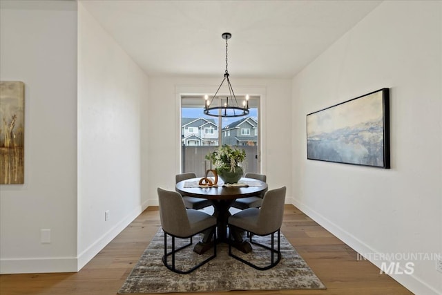 2316 E Valensole St, Meridian, ID 83642 - dining room with a chandelier, baseboards, and wood finished floors